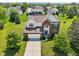Brick home with manicured lawns, mature trees, and a neighborhood pond at 4017 Ivory Ct, Carmel, IN 46074