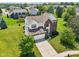 Aerial view of neighborhood home, showcasing its lush landscaping, trees, and pond at 4017 Ivory Ct, Carmel, IN 46074