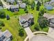 Aerial view showcasing this neighborhood's pond, lush lawns and mature trees at 4017 Ivory Ct, Carmel, IN 46074