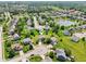Aerial view of residential neighborhood with tree-lined streets and a serene lake at 4017 Ivory Ct, Carmel, IN 46074