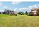 Large, well-maintained backyard with a deck, manicured landscaping, mature trees, and lawn space at 4017 Ivory Ct, Carmel, IN 46074