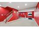 Finished basement featuring vibrant red walls, exercise equipment, and a ping pong table at 4017 Ivory Ct, Carmel, IN 46074