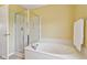 Bright bathroom showing a soaking tub with chrome fixtures, white marble surround, and separate shower at 4017 Ivory Ct, Carmel, IN 46074