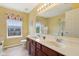 Bathroom featuring a double vanity, large mirror, and natural light at 4017 Ivory Ct, Carmel, IN 46074