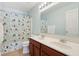 Stylish bathroom featuring double sink vanity, framed mirror, updated lighting, and a colorful shower curtain at 4017 Ivory Ct, Carmel, IN 46074
