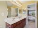 Bright bathroom featuring double sinks, updated vanity, large mirror, and a glass enclosed shower at 4017 Ivory Ct, Carmel, IN 46074