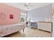 Light-filled bedroom with pink and blue walls, large window, light fixture, and a floral comforter at 4017 Ivory Ct, Carmel, IN 46074