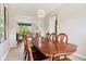 Dining room with chandelier and wood table, which opens to the living room at 4017 Ivory Ct, Carmel, IN 46074