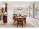 Elegant dining room featuring a wood table, seating for six, decorative chandelier, and large art pieces at 4017 Ivory Ct, Carmel, IN 46074