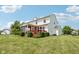 Rear exterior of a home featuring a screened porch and deck, complemented by a well-maintained yard and trees at 4017 Ivory Ct, Carmel, IN 46074