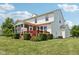 Rear exterior of home with a screened porch and a deck, surrounded by lush landscaping and green lawn at 4017 Ivory Ct, Carmel, IN 46074