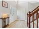 Welcoming foyer with a glass-accented front door, light wood floors, and a charming staircase at 4017 Ivory Ct, Carmel, IN 46074