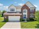 Well maintained exterior with brick facade, lush lawn, and attached garage at 4017 Ivory Ct, Carmel, IN 46074