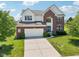 A manicured lawn adds curb appeal to this brick and vinyl home at 4017 Ivory Ct, Carmel, IN 46074