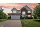 Charming two-story home with brick facade, prominent gables, and an attached two-car garage at 4017 Ivory Ct, Carmel, IN 46074