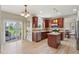 Open kitchen featuring stainless appliances, granite counters, island, and view of outdoor deck at 4017 Ivory Ct, Carmel, IN 46074