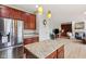 Modern kitchen with stainless steel appliances, granite counters, and a view to the fireplace in the living room at 4017 Ivory Ct, Carmel, IN 46074
