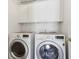 Laundry room featuring a full-sized side-by-side washer and dryer beneath white wall-mounted cabinets at 4017 Ivory Ct, Carmel, IN 46074