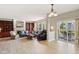 Open concept living room with fireplace, built-in shelving, hardwood floors, and doors to the patio at 4017 Ivory Ct, Carmel, IN 46074