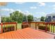 Outdoor deck with wood railing, overlooking the expansive lawn and beautifully landscaped backyard, and neighborhood at 4017 Ivory Ct, Carmel, IN 46074