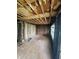 Renovation-ready living room showcasing hardwood floors and exposed framing at 4206 Clark St, Anderson, IN 46013