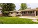 Lawn with patio space for entertaining, accented by stone and siding exterior at 4415 N Illinois St, Indianapolis, IN 46208
