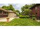 Landscaped backyard with well-kept grass, potted plants and neighboring houses at 4415 N Illinois St, Indianapolis, IN 46208
