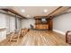 Spacious basement with a bar, wood-style flooring, and ample space for recreation, perfect for entertaining at 4415 N Illinois St, Indianapolis, IN 46208