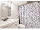 Cozy bathroom featuring a floral shower curtain, vanity, and ample lighting, providing a functional and inviting space at 4415 N Illinois St, Indianapolis, IN 46208
