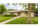 Charming ranch-style home with a stone facade, manicured lawn, and mature trees at 4415 N Illinois St, Indianapolis, IN 46208