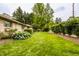 Manicured front yard with vibrant green grass, mature trees, and well-maintained landscaping at 4415 N Illinois St, Indianapolis, IN 46208