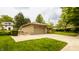 A single-story garage with a paved driveway bordered by greenery and lush trees at 4415 N Illinois St, Indianapolis, IN 46208