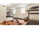 Brightly lit home gym with treadmill, bench, mirrored wall and laminate wood flooring at 4415 N Illinois St, Indianapolis, IN 46208