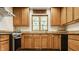 Traditional kitchen with warm wood cabinetry, granite countertops, and stainless steel appliances at 4415 N Illinois St, Indianapolis, IN 46208