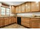 Kitchen features ample wooden cabinetry, granite countertops, and a black dishwasher, offering functionality at 4415 N Illinois St, Indianapolis, IN 46208