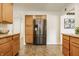 Kitchen area featuring wooden cabinets, stainless steel refrigerator, and easy access to dining area at 4415 N Illinois St, Indianapolis, IN 46208