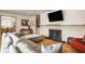 Cozy living room featuring a stone fireplace, hardwood floors, and comfortable furnishings at 4415 N Illinois St, Indianapolis, IN 46208