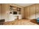 Well-lit living room with hardwood floors, built-in shelves and cabinets for storage and display at 4415 N Illinois St, Indianapolis, IN 46208