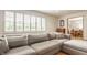 Cozy living room bathed in natural light from the large windows with an open view to the dining area at 4415 N Illinois St, Indianapolis, IN 46208