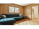 Charming living room with a plush blue sectional, hardwood floors, and a bright window, perfect for relaxing and entertaining guests at 4415 N Illinois St, Indianapolis, IN 46208