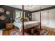 Elegant main bedroom with four-poster bed, hardwood floors, and decorative accents, creating a serene and inviting space at 4415 N Illinois St, Indianapolis, IN 46208