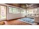 Comfortable sunroom featuring a ceiling fan, bright windows, and a cozy seating area, perfect for relaxation and enjoying the outdoors at 4415 N Illinois St, Indianapolis, IN 46208