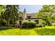 A well-manicured backyard featuring a wooden deck and lush green lawn at 4428 Edinburgh Pt, Indianapolis, IN 46228