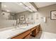 Bathroom featuring double sinks, modern fixtures and a glass door shower at 4428 Edinburgh Pt, Indianapolis, IN 46228