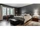 Stylish bedroom features large window, hardwood flooring, desk and queen-sized bed at 4428 Edinburgh Pt, Indianapolis, IN 46228