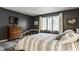 Stylish bedroom featuring a large window, hardwood floors, and neutral colors at 4428 Edinburgh Pt, Indianapolis, IN 46228