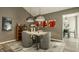 Elegant dining room with pendant lighting, neutral decor, and seating for four at 4428 Edinburgh Pt, Indianapolis, IN 46228