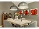 Inviting dining room features modern light fixtures, colorful flower paintings, and seating for four at 4428 Edinburgh Pt, Indianapolis, IN 46228