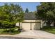Spacious two-car garage with a paved driveway and manicured lawn at 4428 Edinburgh Pt, Indianapolis, IN 46228