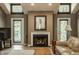 Cozy living room with fireplace, vaulted ceilings, and stylish hardwood flooring at 4428 Edinburgh Pt, Indianapolis, IN 46228